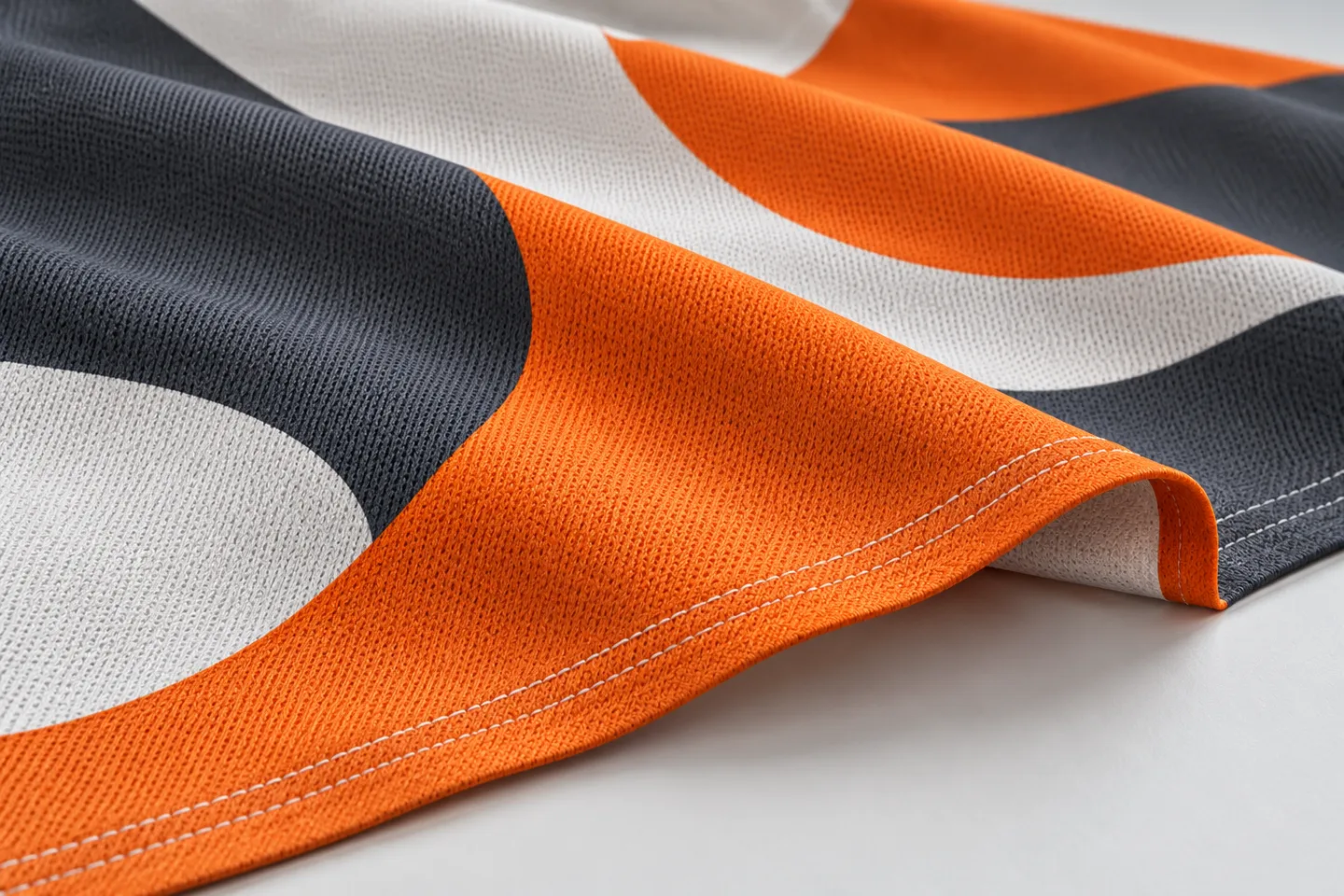 Illustration of fabric and hemming. Your flag uses your artwork; the pictured design is an example.